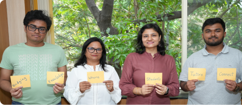 The CTutor team holding up handwritten cards that read Bridging, Knowledge, Where, Students, Tutors, Connect