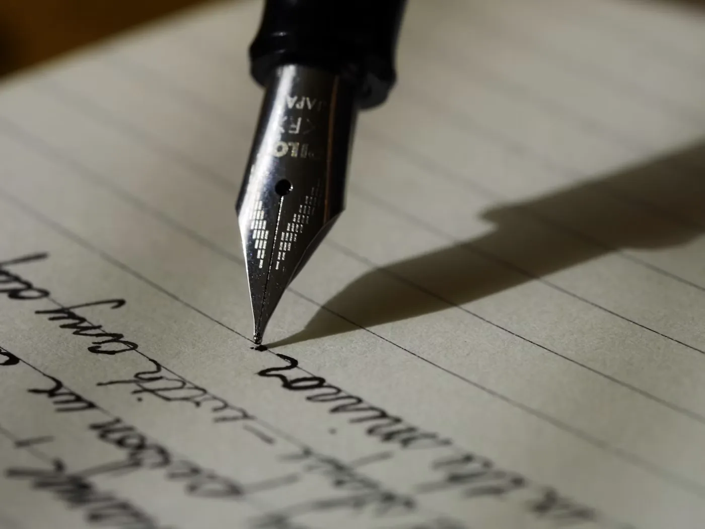 Close-up of a fountain pen nib writing on paper