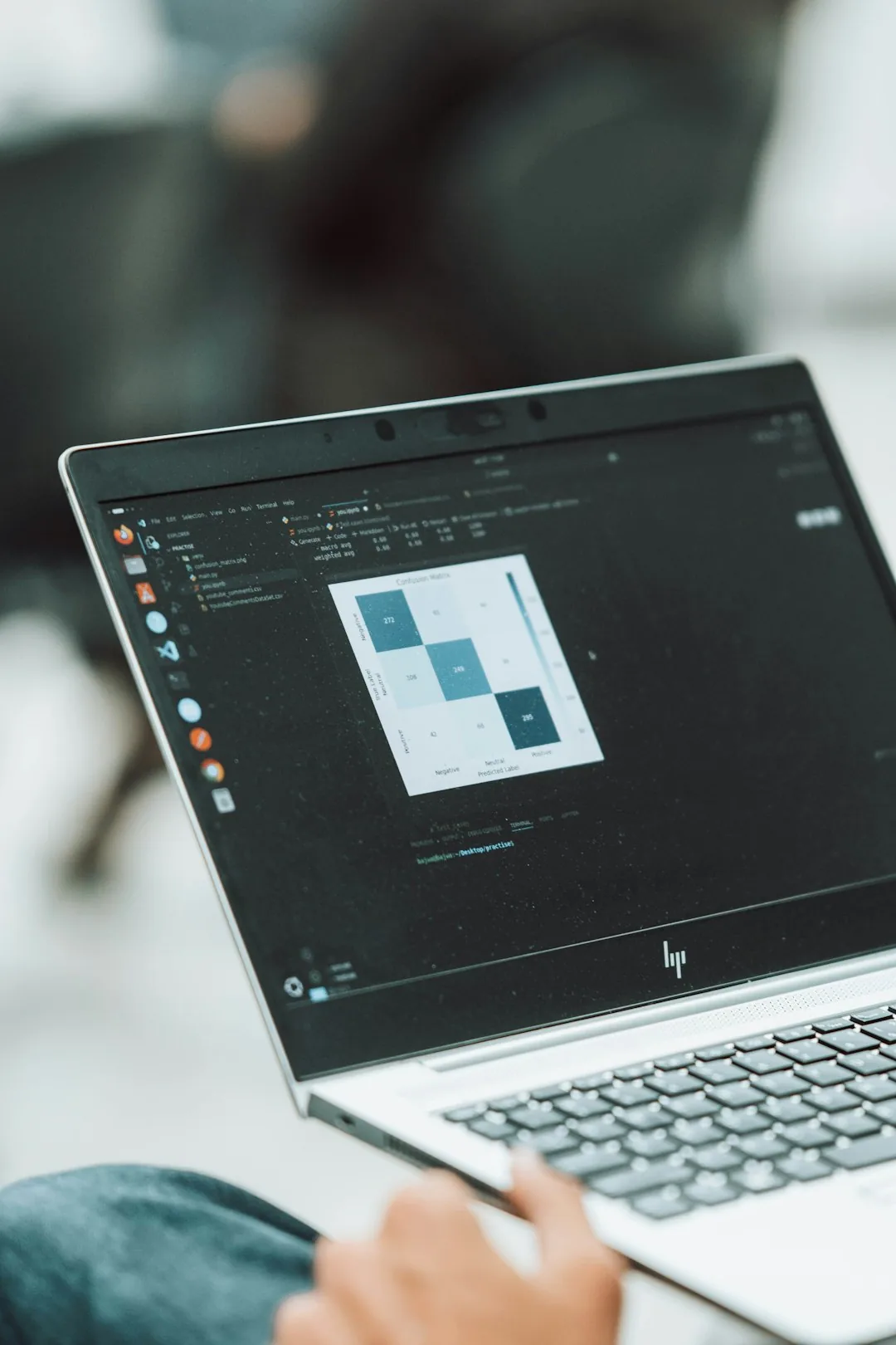 Laptop screen showing a coding editor with a small grid of coloured squares