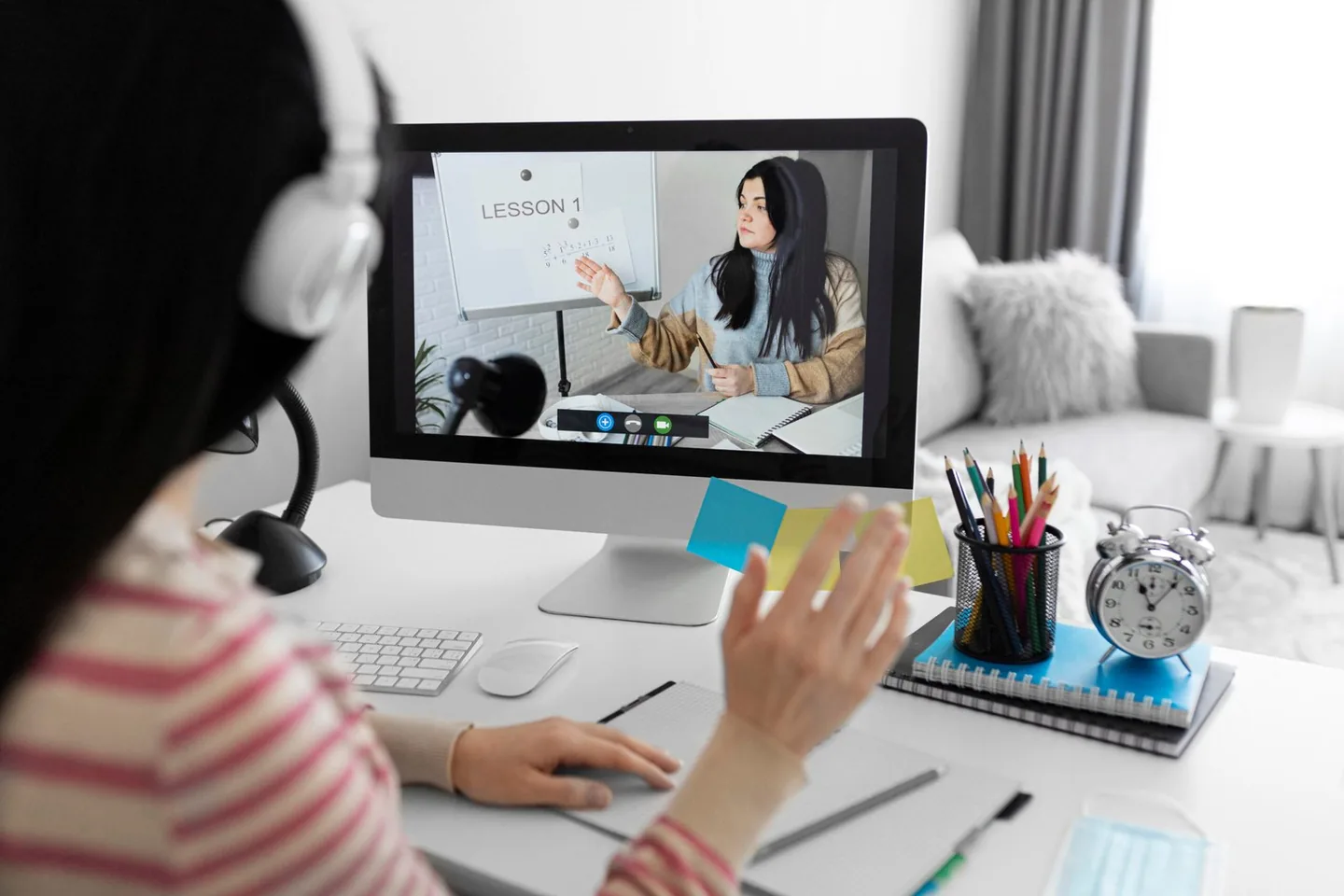 Student on a video lesson with a tutor on a desktop screen
